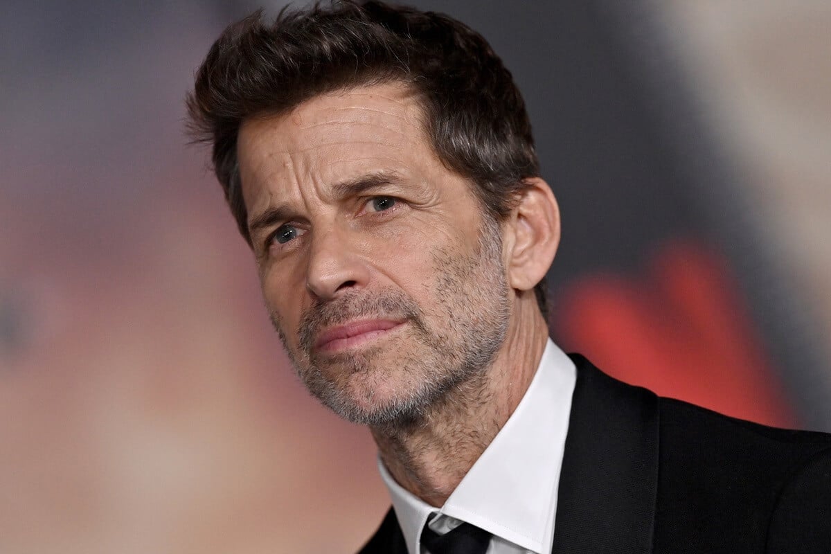 Zack Snyder posing at the premiere of 'Rebel Moon' in a suit.