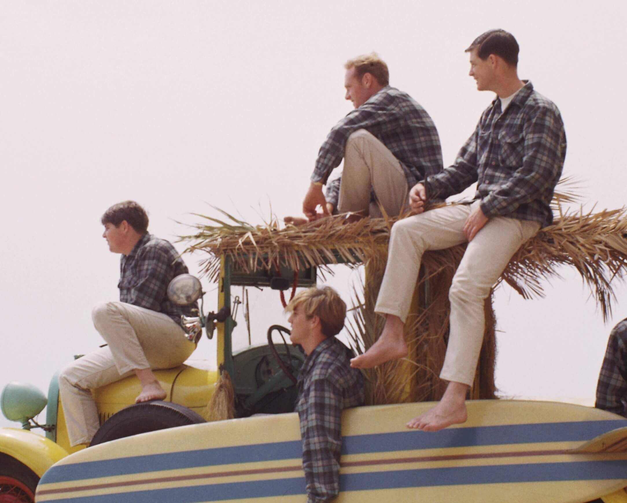 The Beach Boys sitting on a car