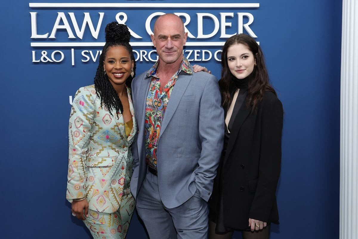 Chris Meloni sposing between Danielle Truitt and Ainsley Seiger.