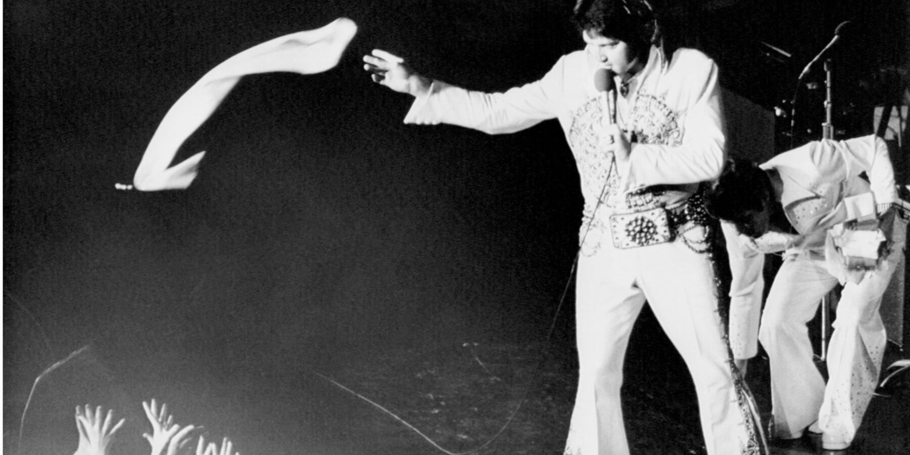 Elvis Presley in concert handing out scarves