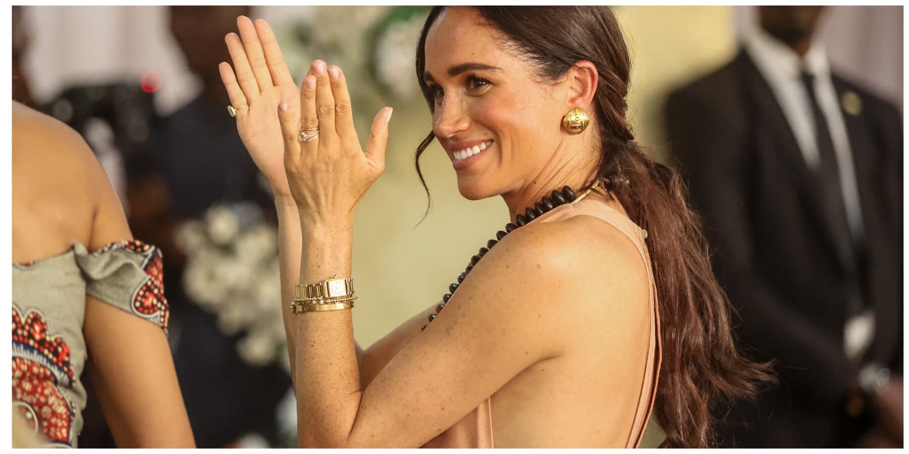 Meghan Markle claps during a visit to Nigeria