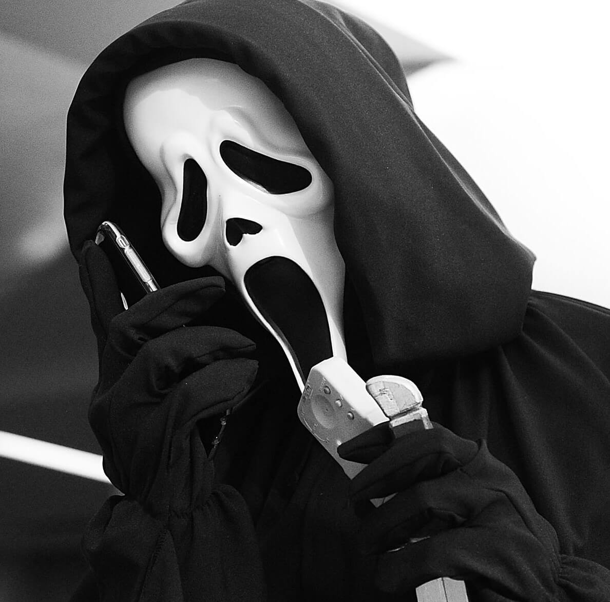 Ghostface from Wes Craven's 'Scream' with a phone