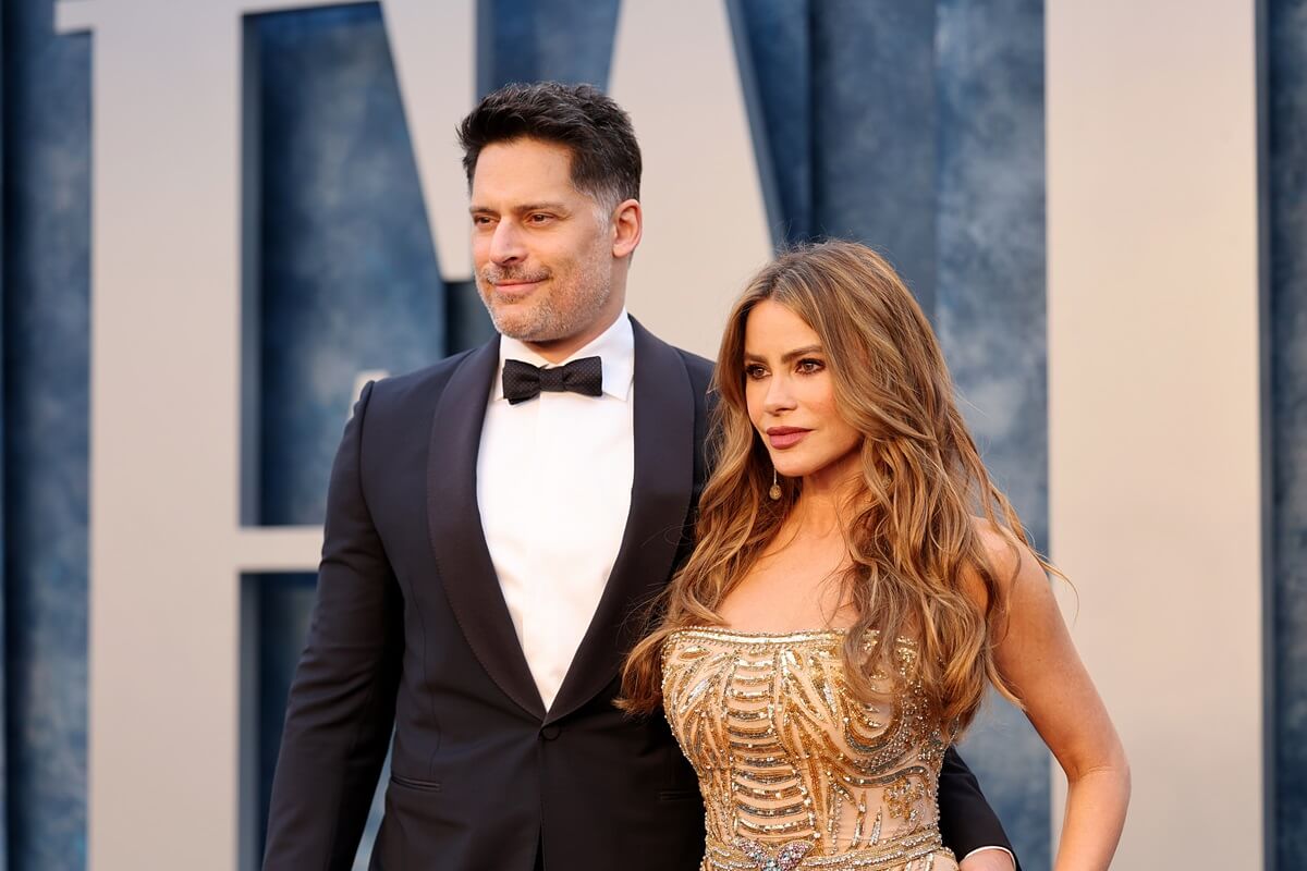 Joe Manganiello and Sofia Vergara posing in a suit and dress at the 2023 Vanity Fair Oscar Party Hosted By Radhika Jones.