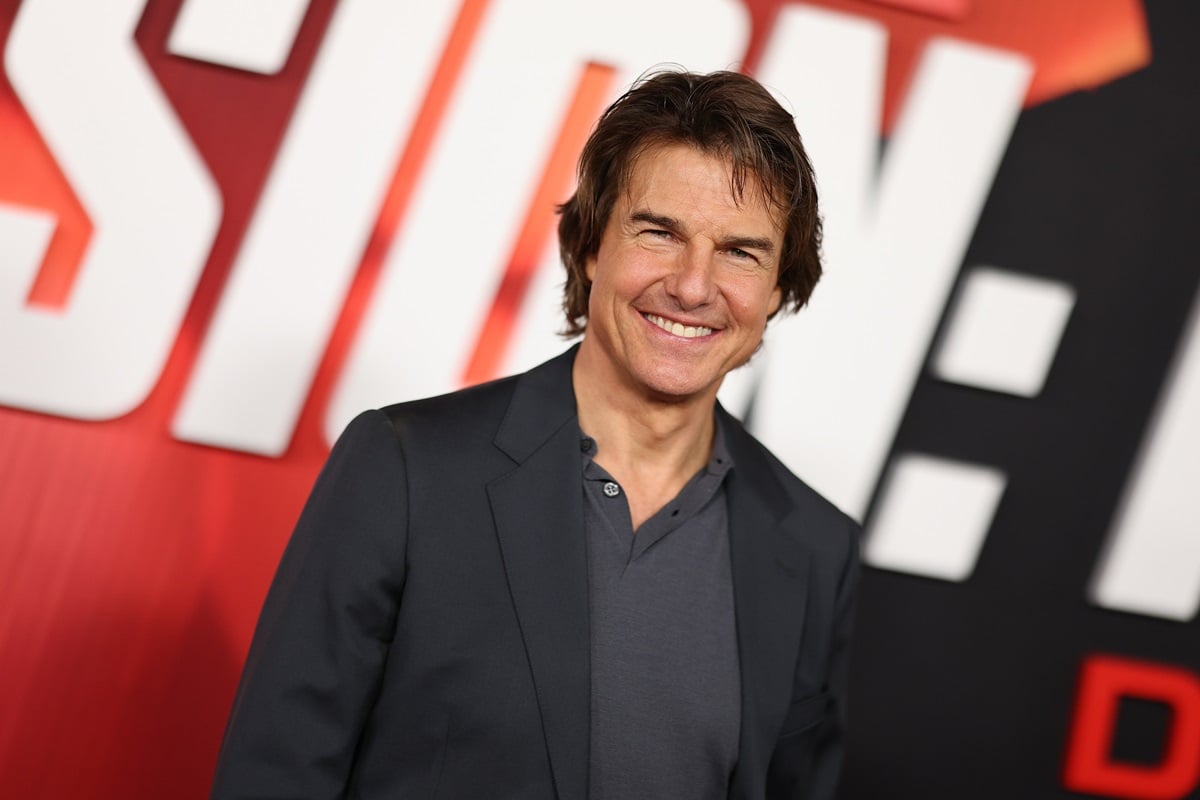 Tom Cruise posing in a black outfit at the premiere of 'Mission Impossible: Dead Reckoning'.