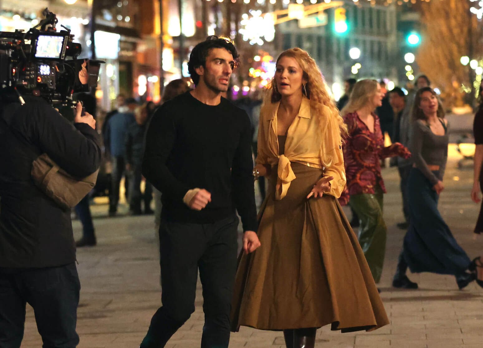 Justin Baldoni and Blake Lively talking to each other while filming 'It Ends With Us' during an outdoor night scene in January