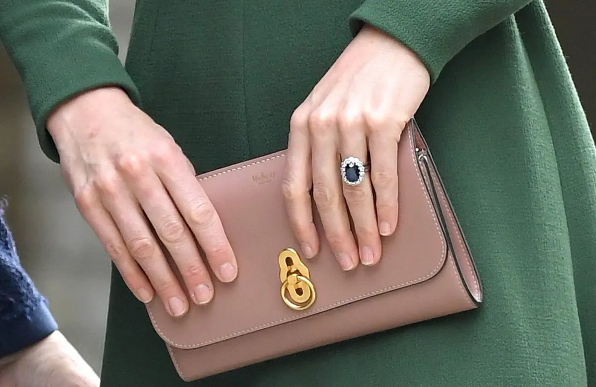 Image of Kate Middleton clutching one of her handbags as she arrives to open the new Centre of Excellence at Anna Freud Centre in London, England