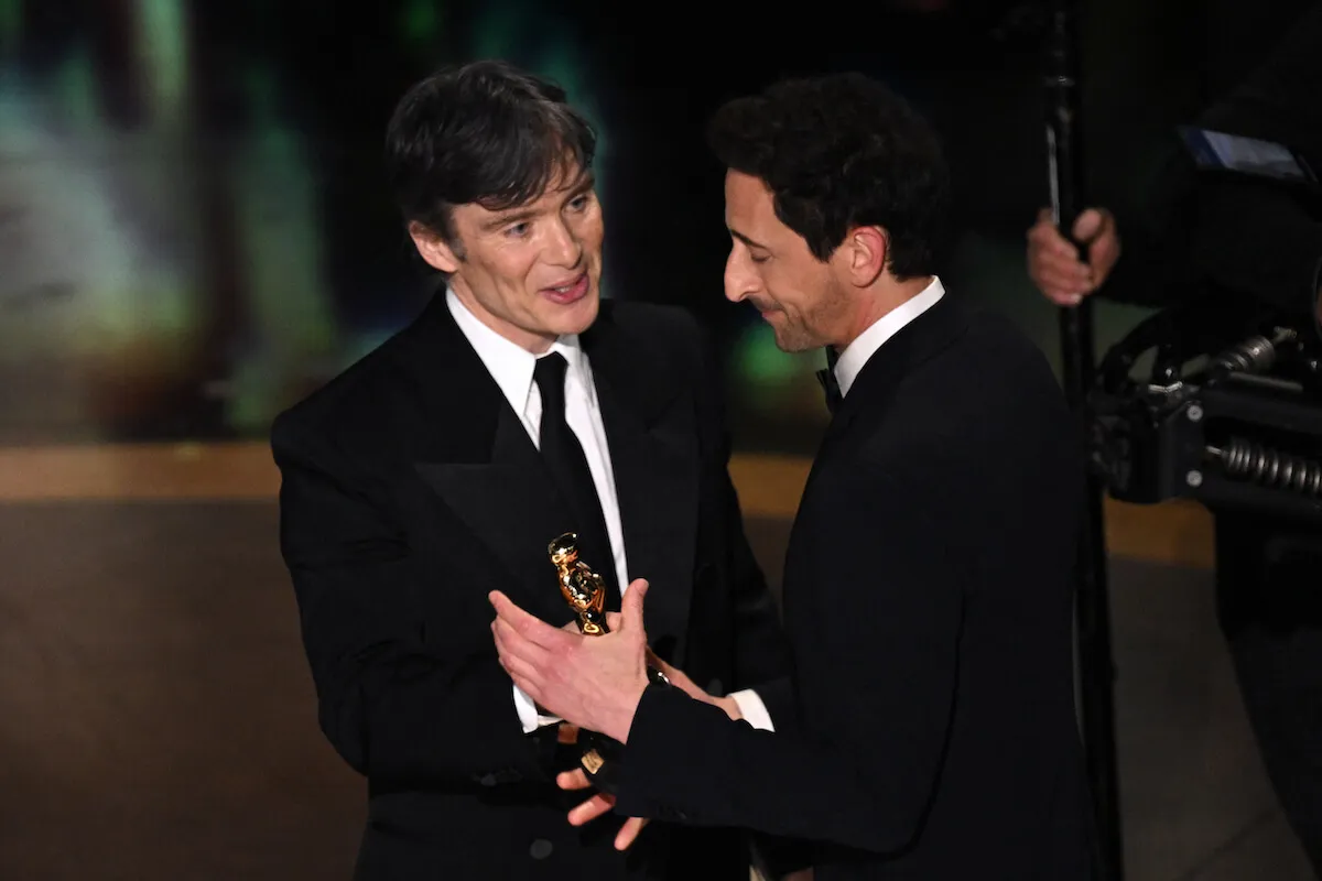 Cillian Murphy gives Adrien Brody his Best Actor statuette at the 2025 Oscars