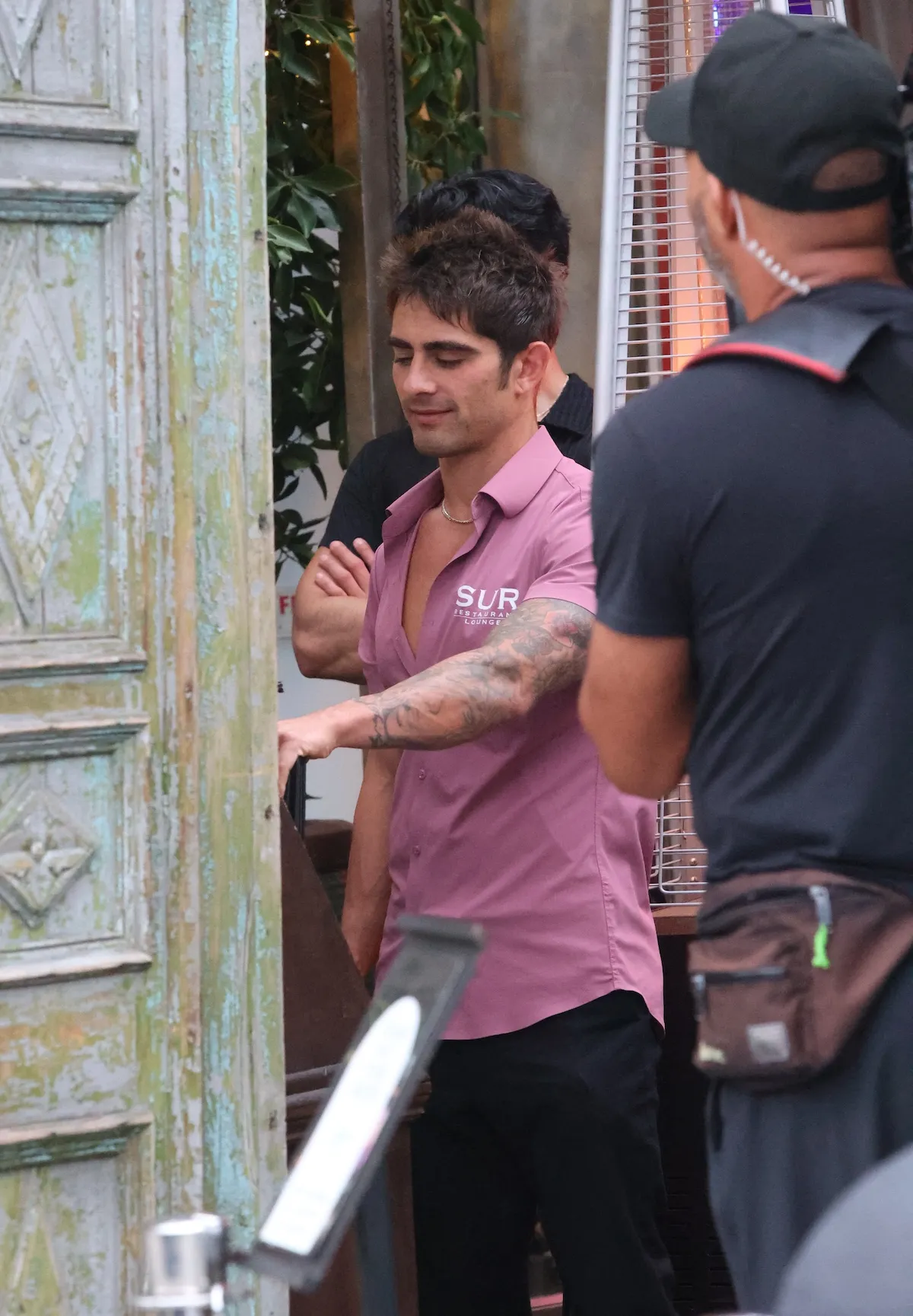 Man in pink shirt filming 'Vanderpump Rules' outside SUR in West Hollywood