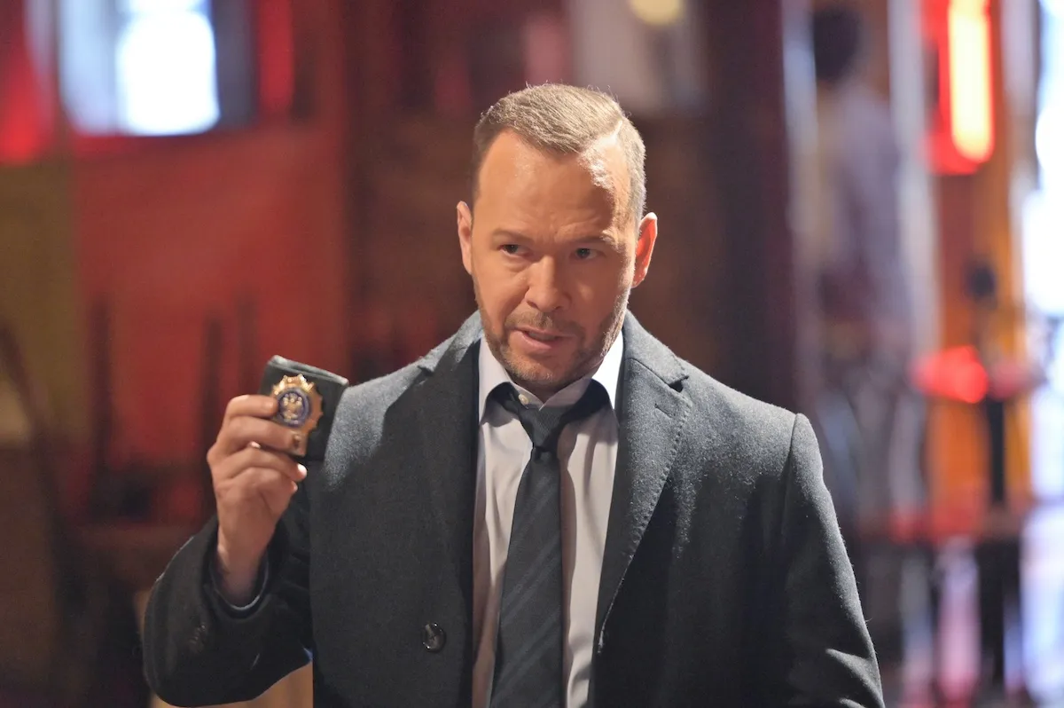 Donnie Wahlberg as Danny Reagan holding up a badge