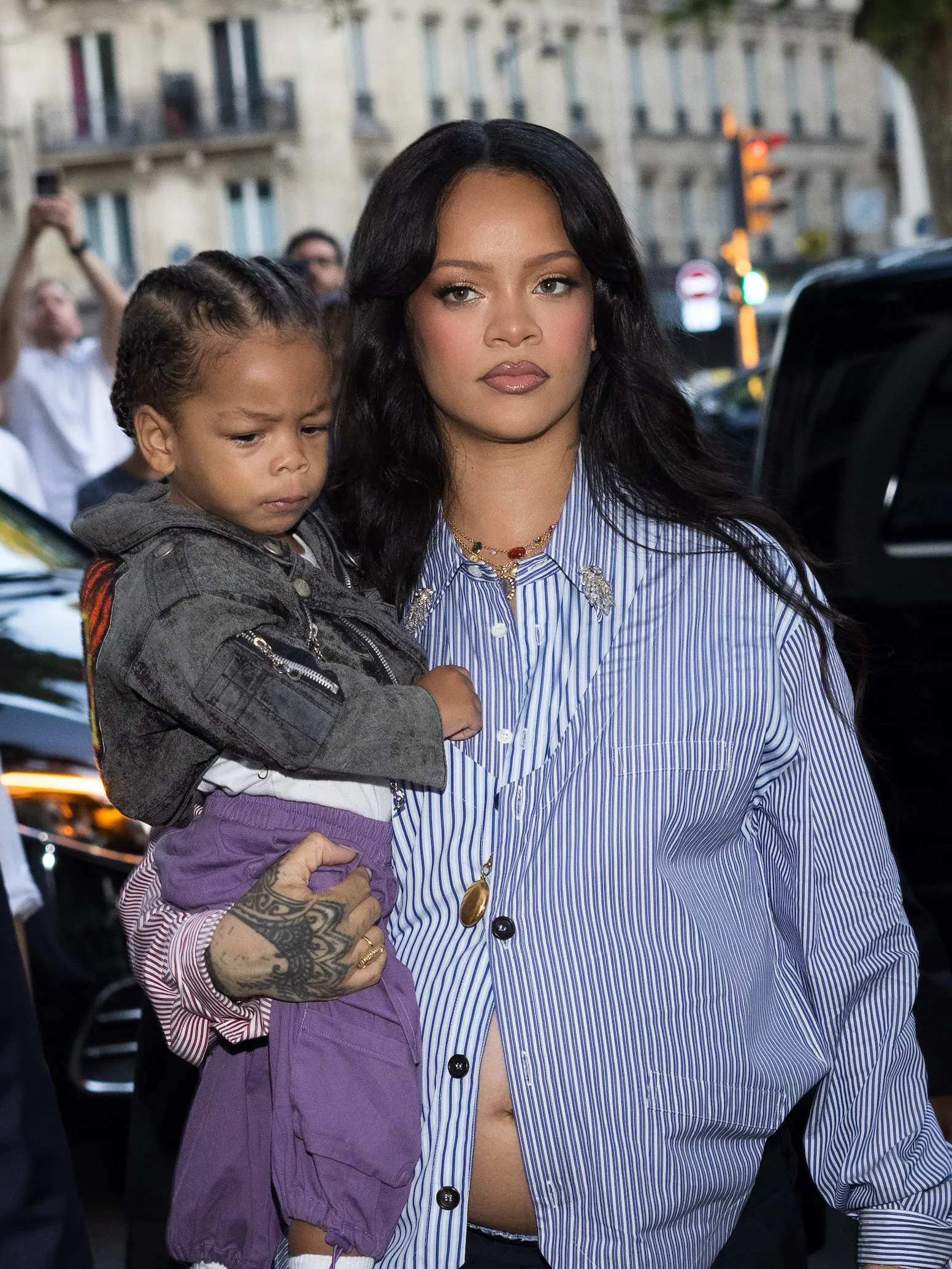 Rihanna holdering her son, Riot, at Paris Fashion Week in 2025