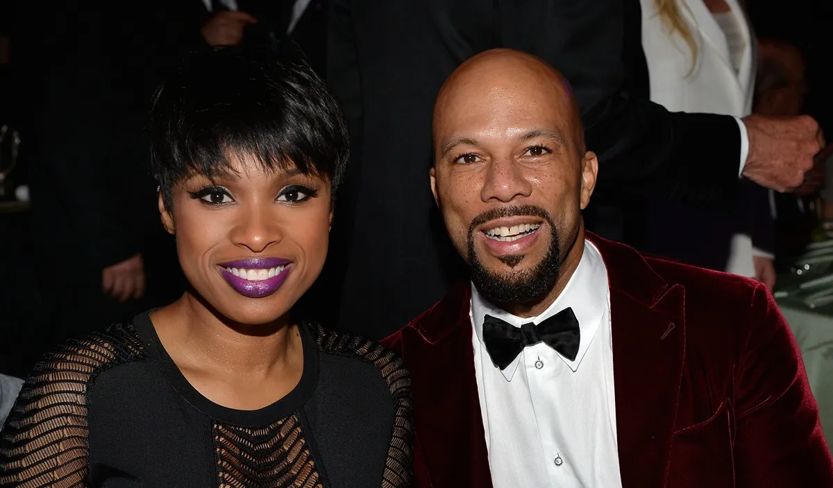 Jennifer Hudson and Common at a public event, smiling and holding hands