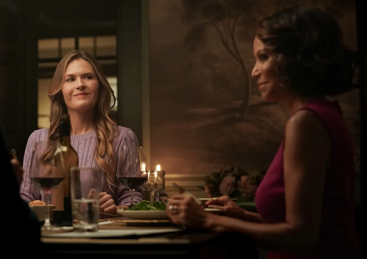 Maggie Lawson and Gloria Reuben sitting at a dining table in 'Boston Blue' series premeire