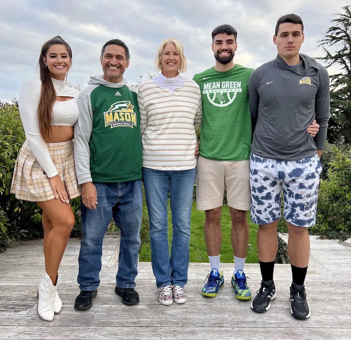 Model Marie Temara with her brothers, Troy and Shane, and her parents. They are standing together and smiling.