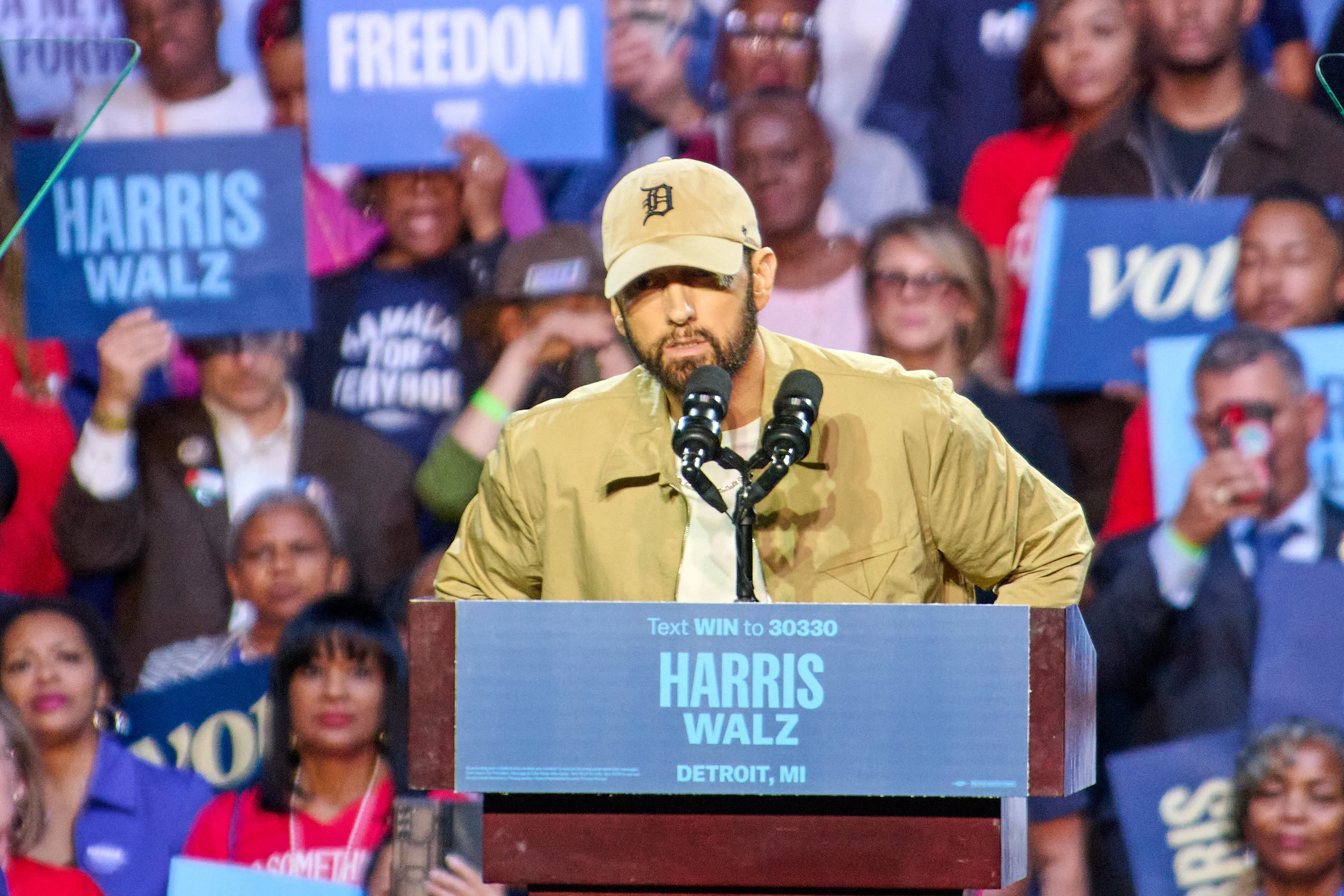 Wearing a Detroit hat, Eminem introduces former president Barack Obama during a rally for Kamala Harris