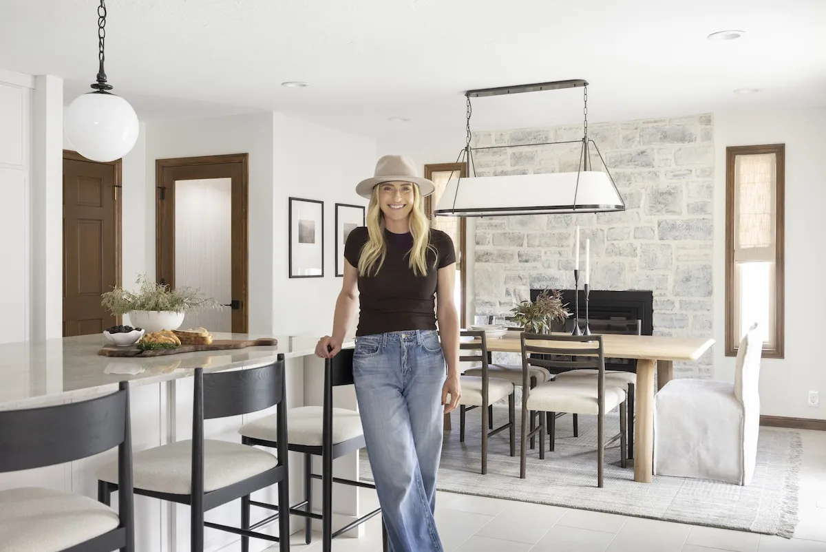 Jasmine Roth of HGTV's 'Help! I Wrecked My Housse' wearing a hat and standing in a neutral-toned room