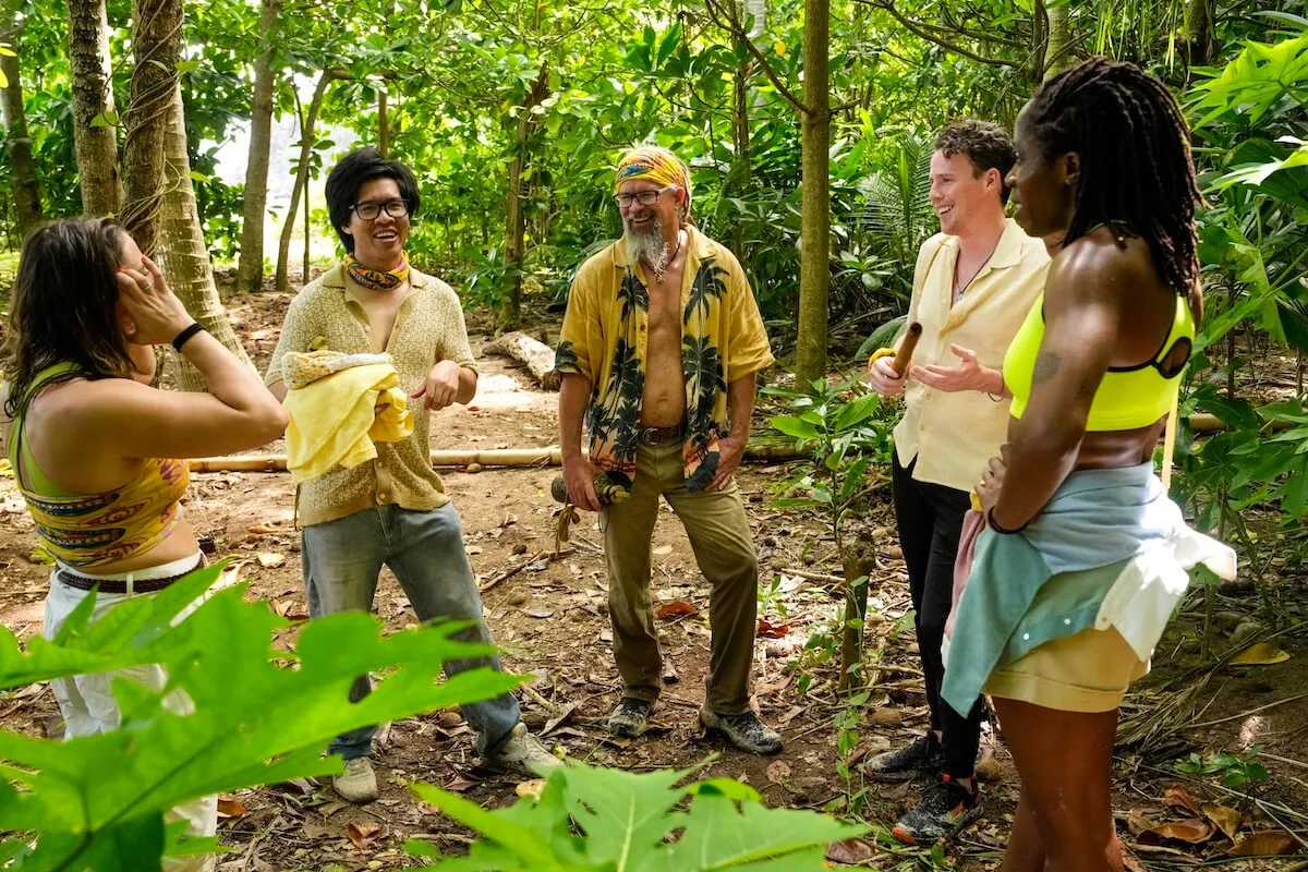 Group of Survivor 49 contestants standing in the woods