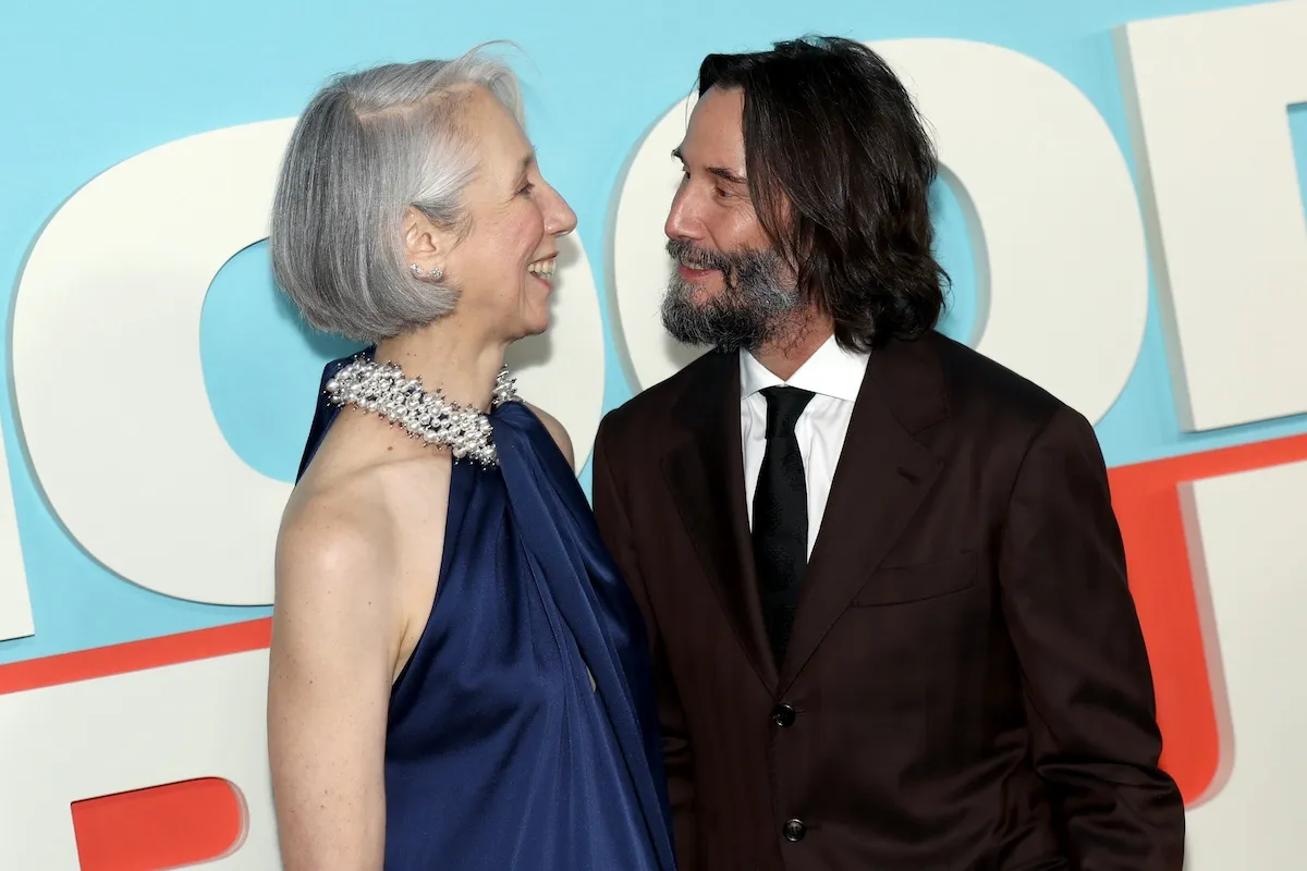 Alexandra Grant and Keanu Reeves looking at each other at the 'Good Fortune' premiere
