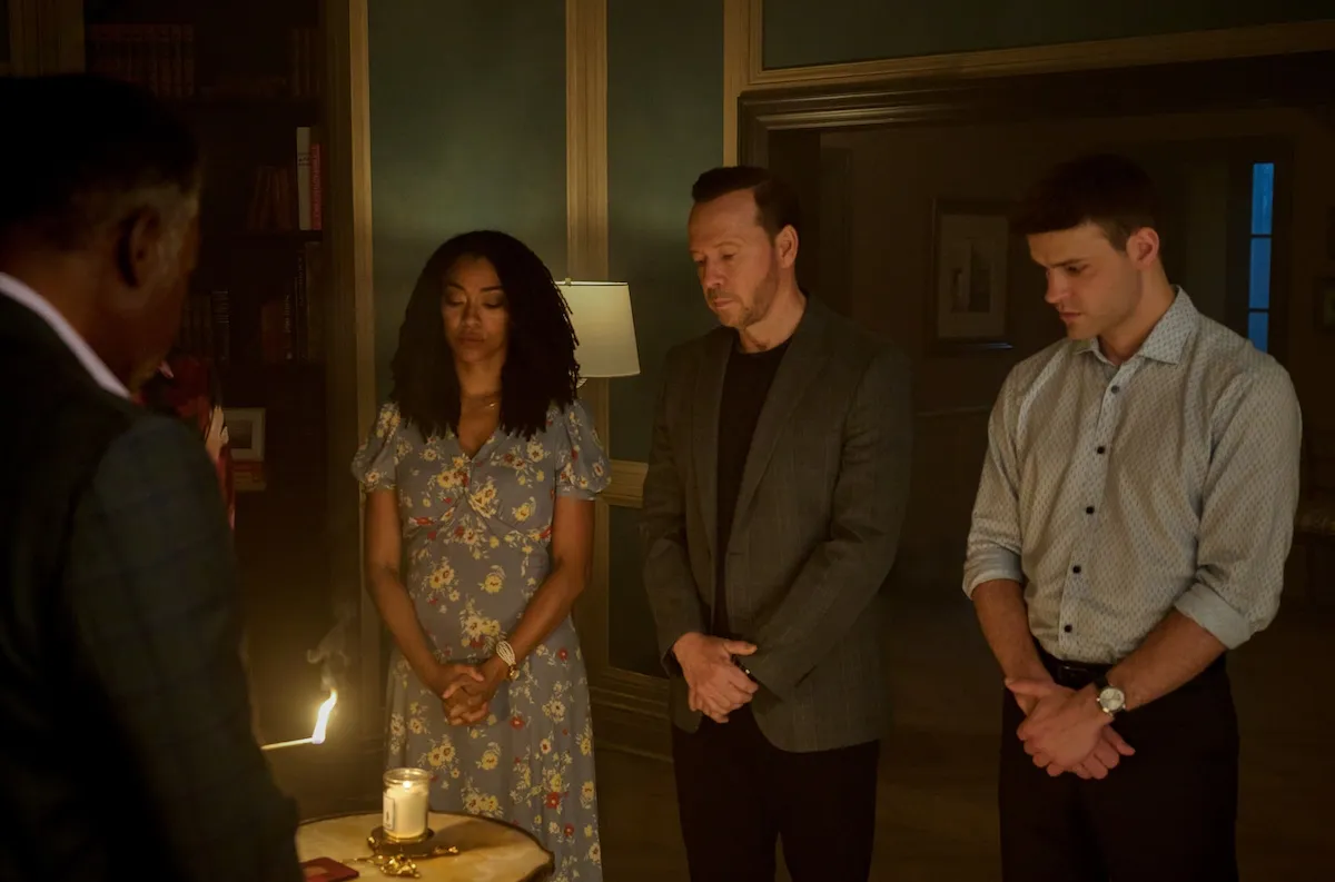 'Boston Blue' cast members standing around a dinner table