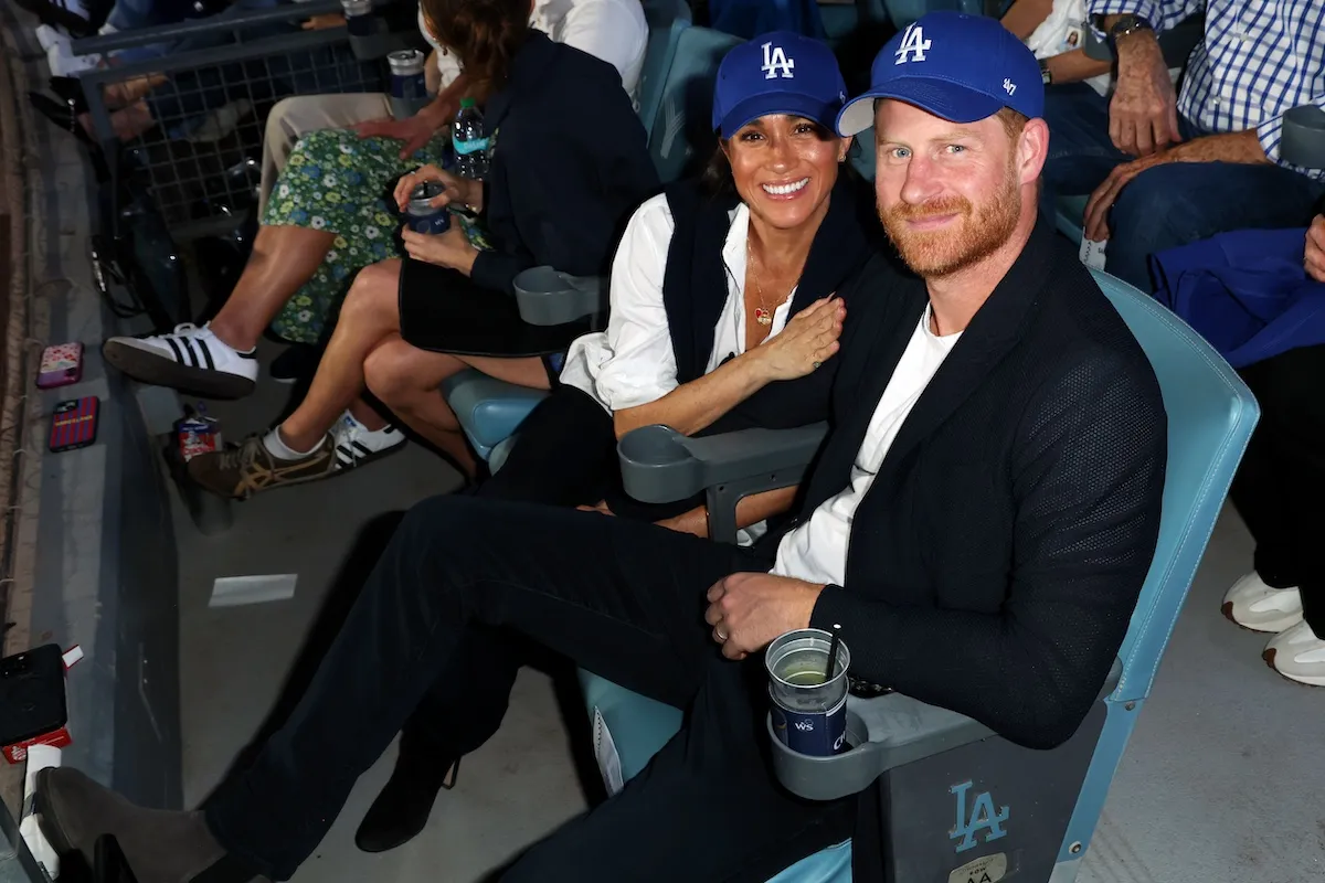 Meghan Markle and Prince Harry wearing LA Dodgers hats