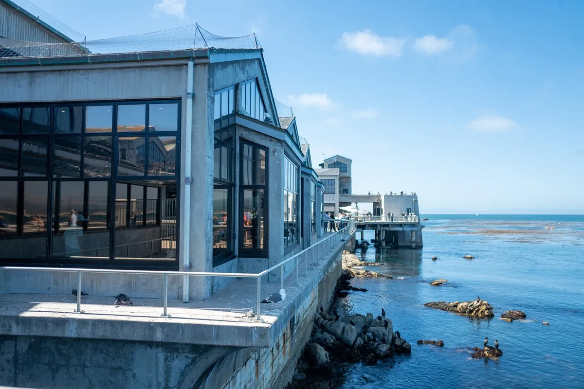 Side view of Monterey Bay Aquarium with waters of Monterey Bay visible, Monterey, California, August 5, 2025.