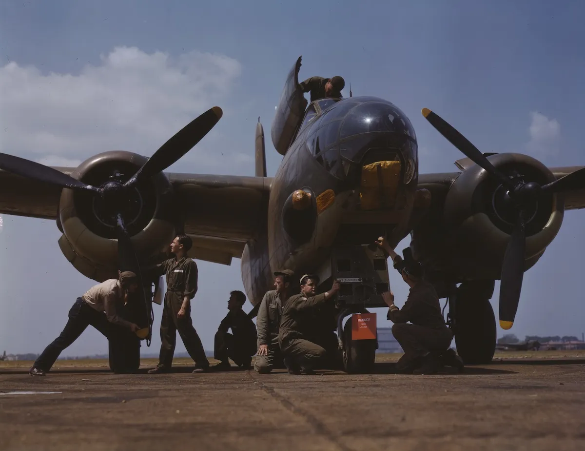People working on a WWII bomber
