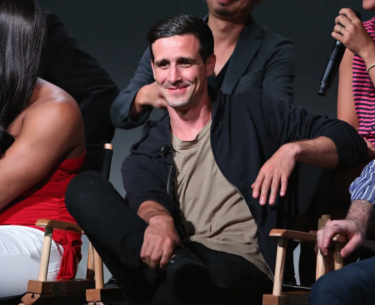 Wearing a black hoody and green tee shirt, James Ransone smiles at fans during a movie event in 2015