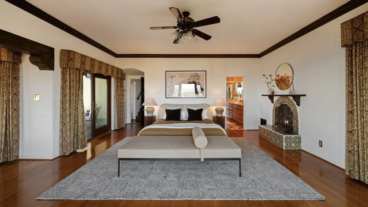 A bedroom with a tile fireplace in a house Frank Sinatra once lived in