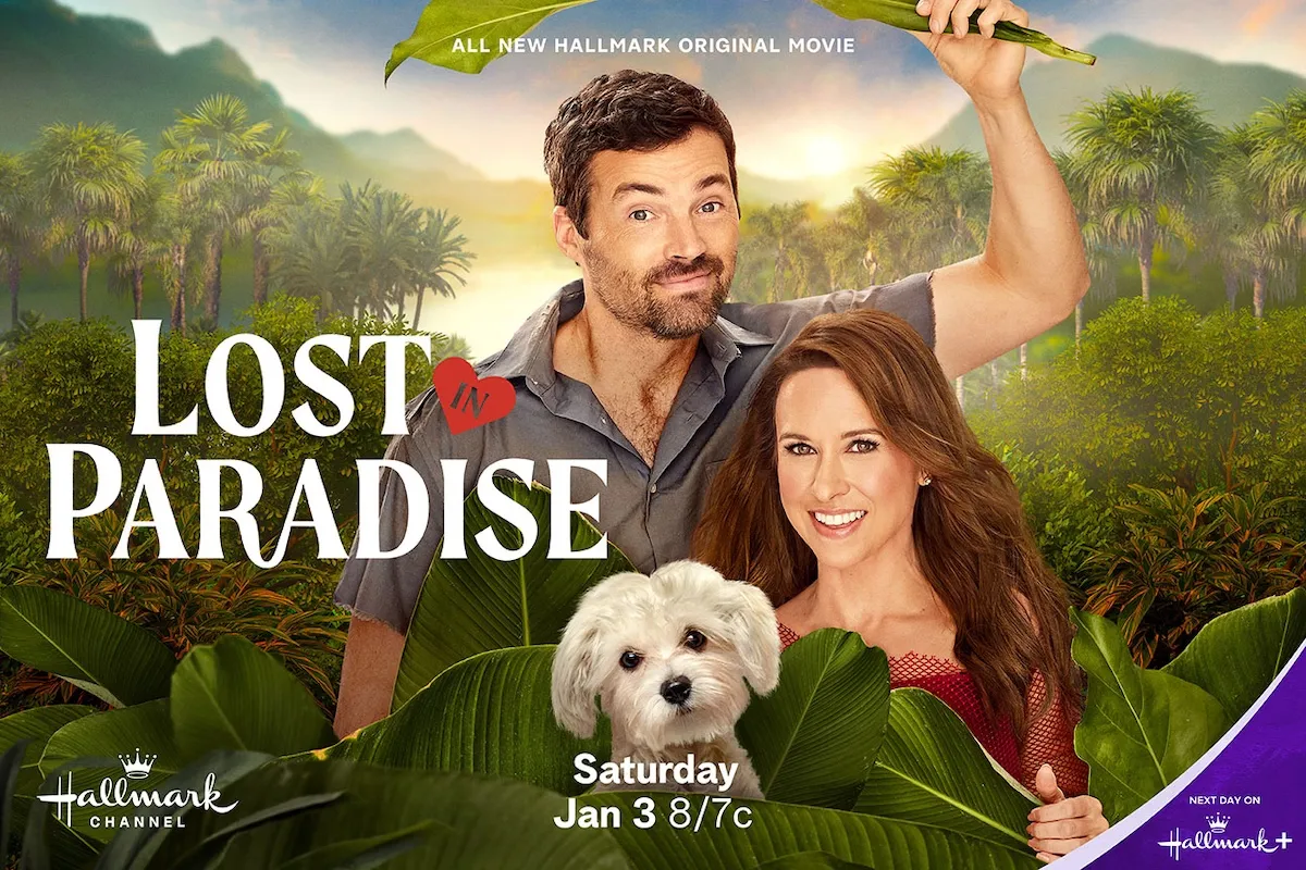 Lacey Chabert, a man, and a cute white dog in post for Hallmark's 'Lost in Paradise'