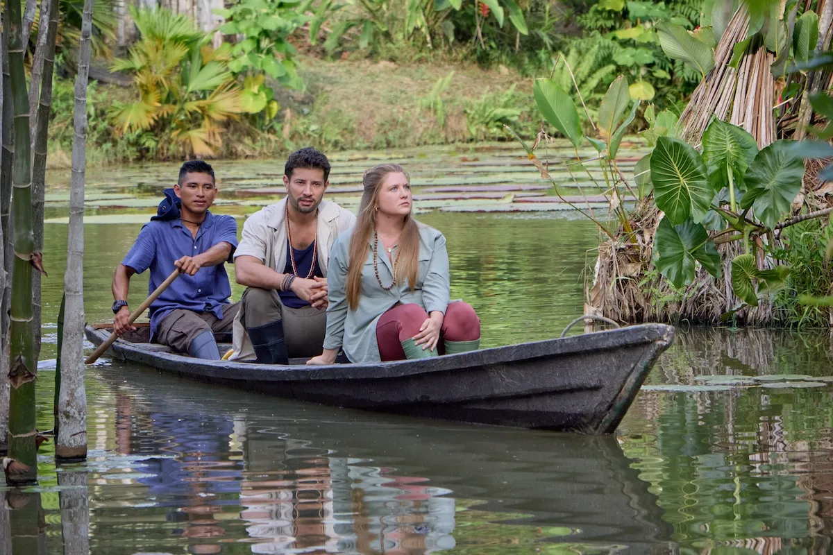 A woman and two men in a canoe on the river in Hallmark's 'Love on the Amazon'