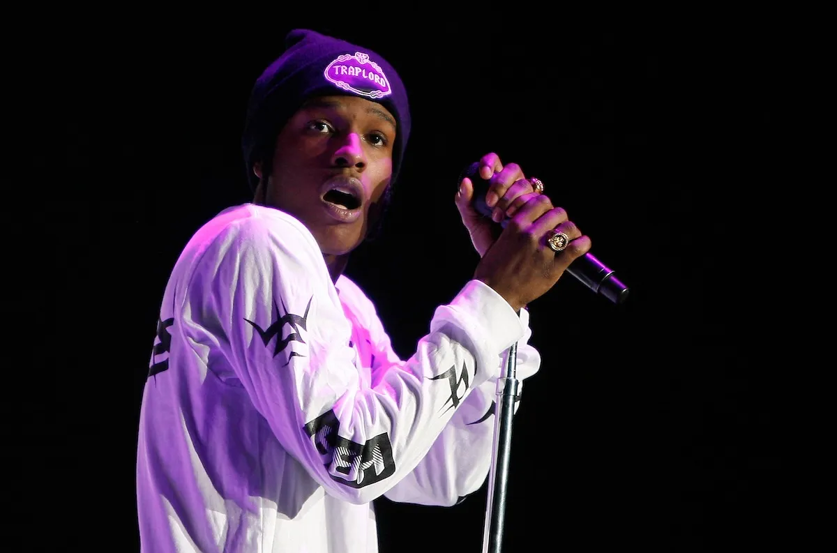A close-up of rapper A$AP Rocky looking surprised while holding the microphone