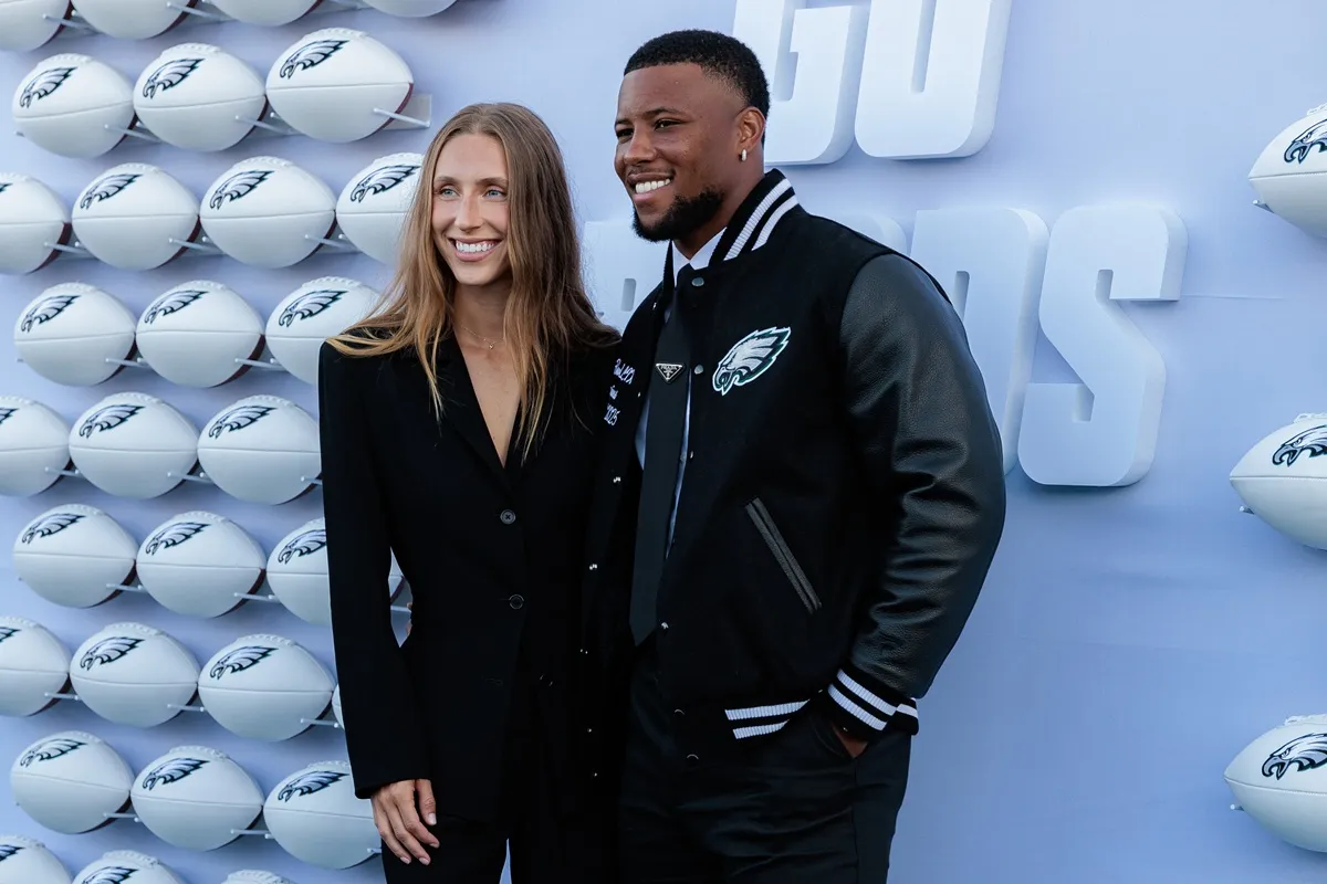 Anna Congdon and Saquon Barkley pose for photographs on the Green Carpet during the Philadelphia Eagles Super Bowl ring ceremony