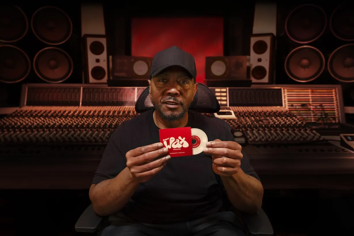 Timbaland holding up Babybel's Mini Wax Tracks