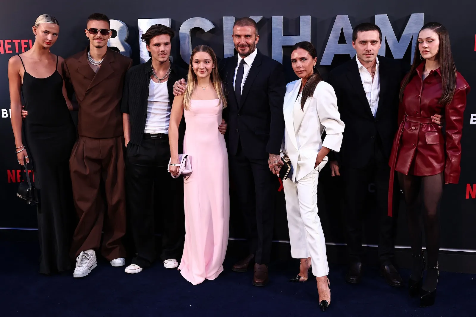 David Beckham and his wife, Victoria Beckham, pose on the red carpet with their children, and partners, (from L) Mia Regan, Romeo Beckham, Cruz Beckham, Harper Beckham, Brooklyn Beckham, and Nicola Peltz Beckham