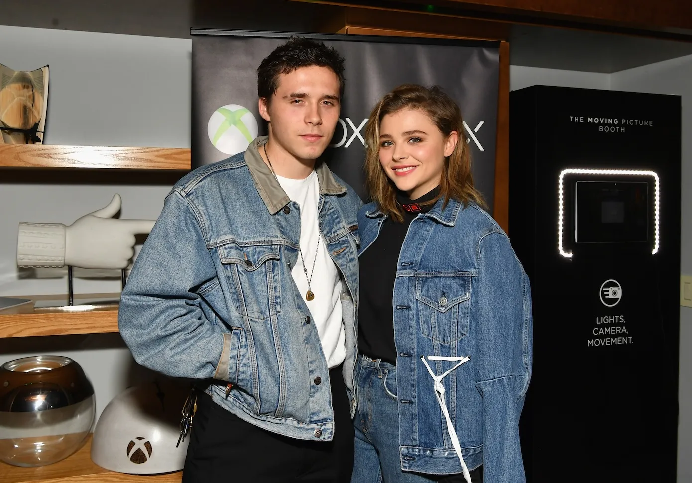 Chloe Grace Moretz and Brooklyn Beckham wearing denim jackets and posing in 2017