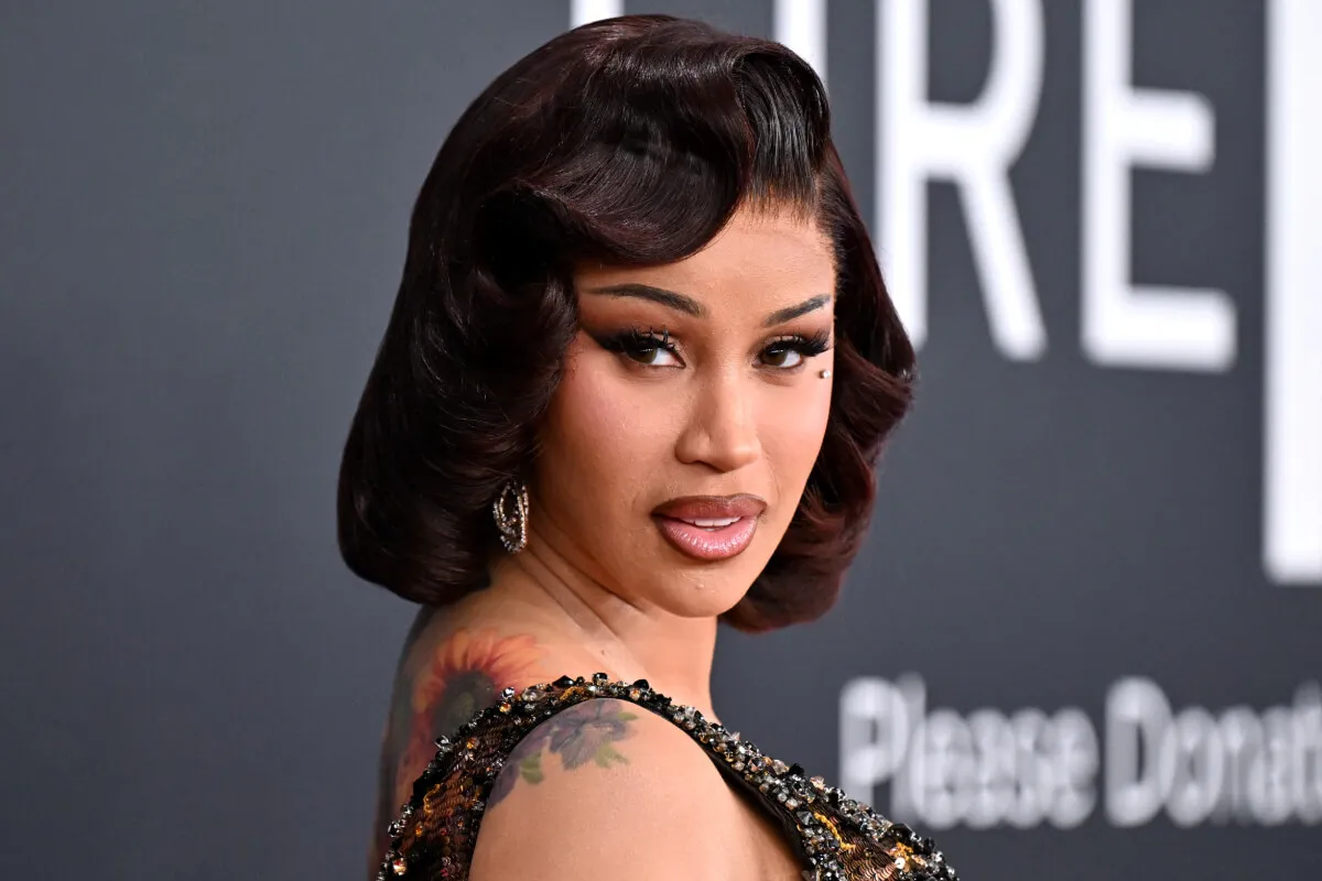 Cardi B wears a rhinestoned dress. Her hair is in a bob.