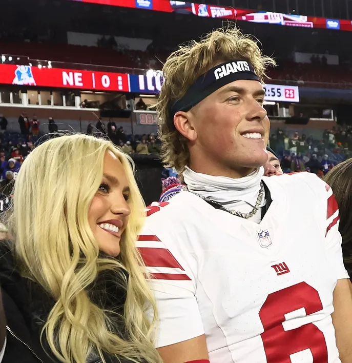 Jaxson Dart #6 of the New York Giants poses with his girlfriend Marissa Ayers before their game against the New England Patriots at Gillette Stadium on December 2, 2025