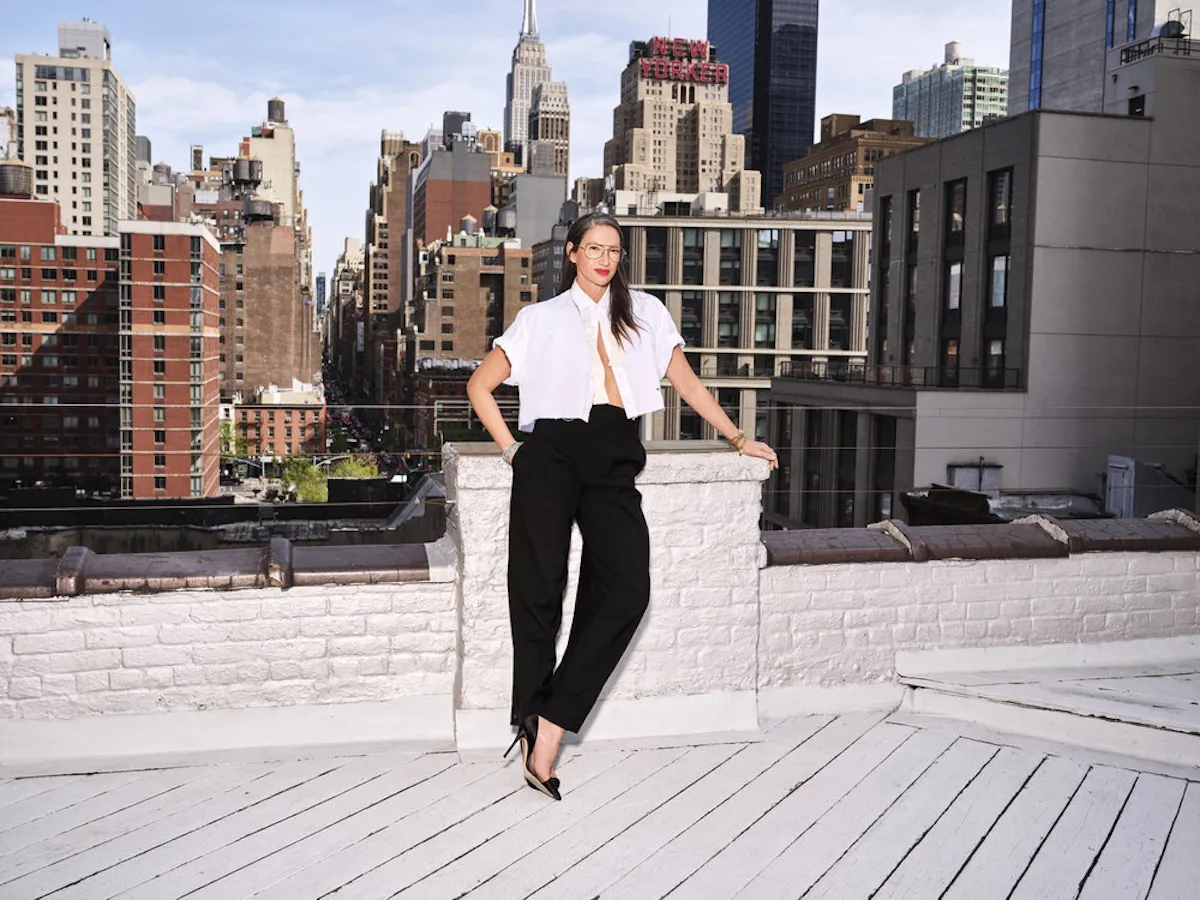 Jenna Lyons of 'RHONY' poses on a rooftop with the city skyline in the background