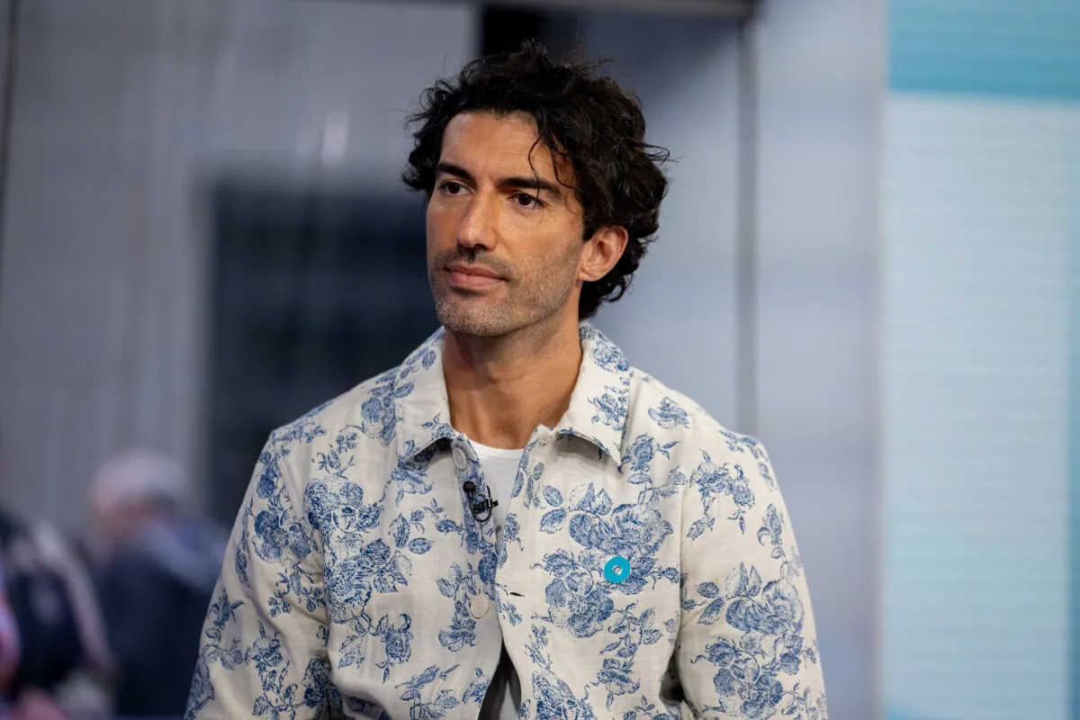 Justin Baldoni wears a white jacket with a blue floral print.