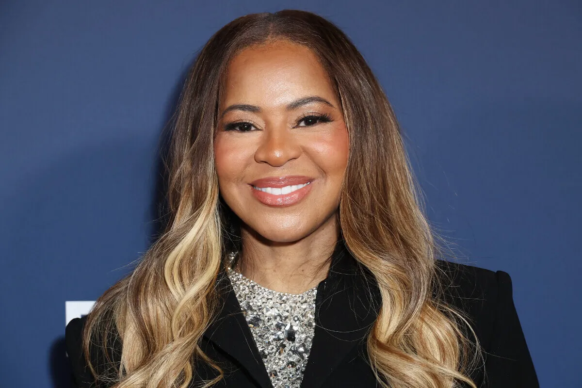 Mary Cosby wears a black blazer and a diamond collar necklace.