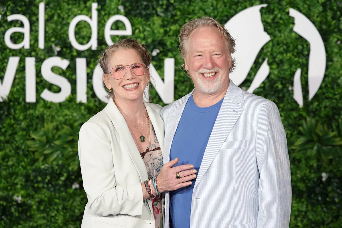 Melissa Gilbert poses for a photo with Timothy Busfield, both wearing white jackets