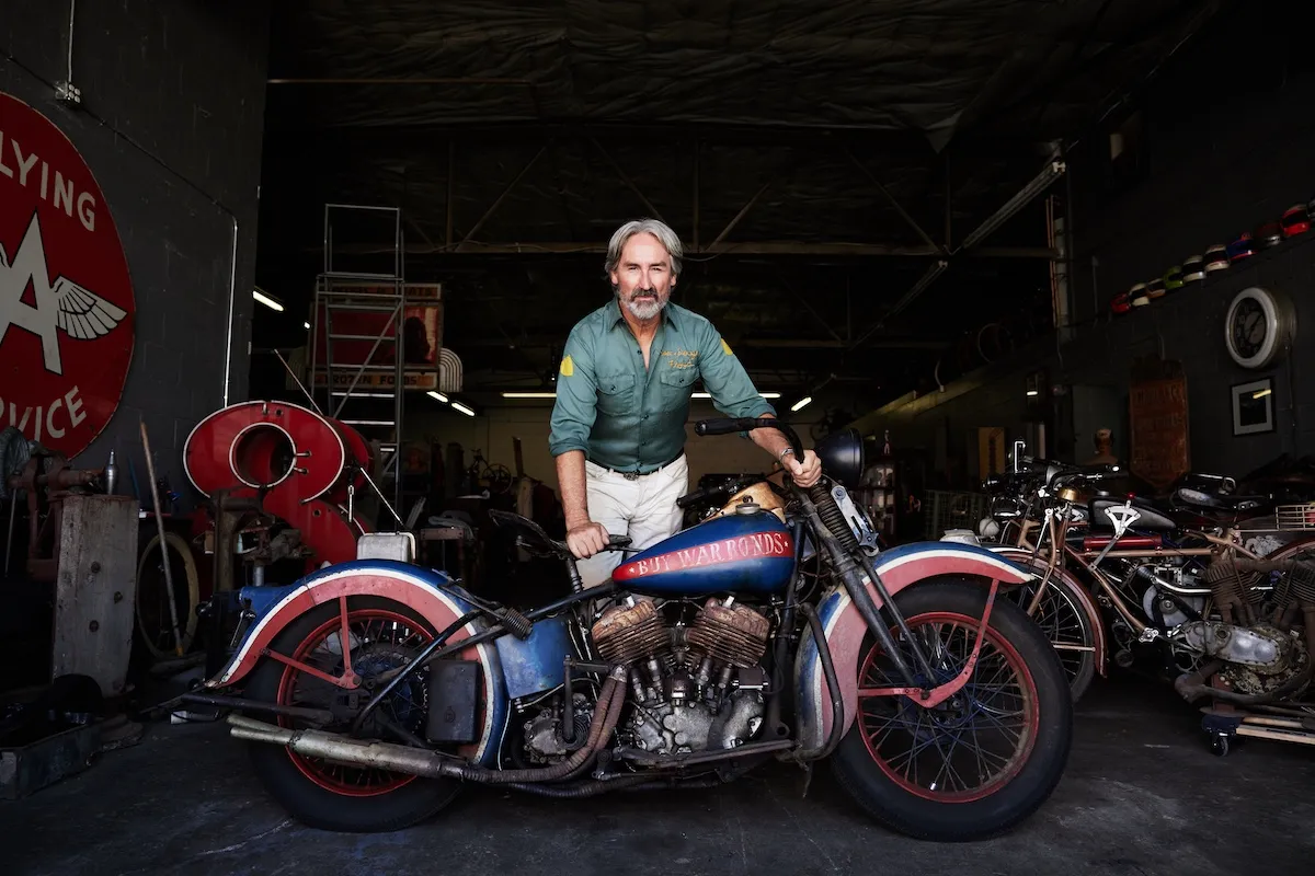 Mike Wolfe of 'American Pickers' posing with a motorcycle