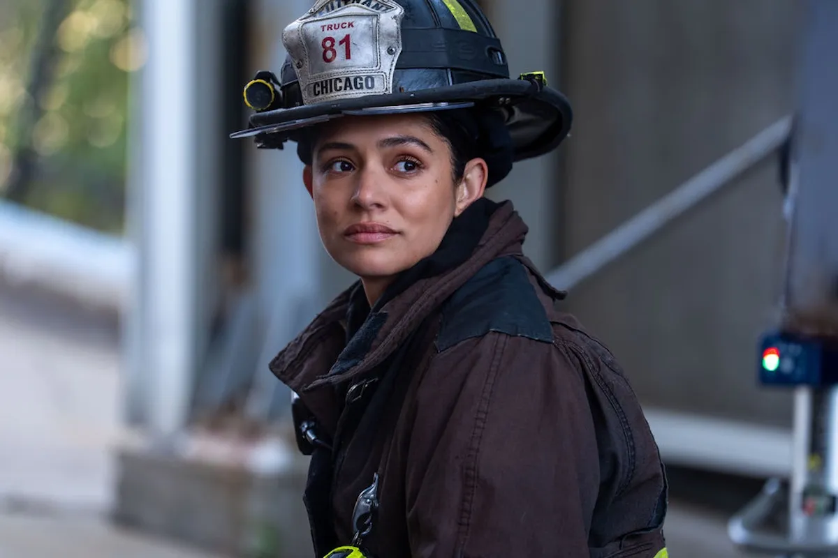 Miranda Rae Mayo as Stella Kidd wearing a firefighter's hat and coat