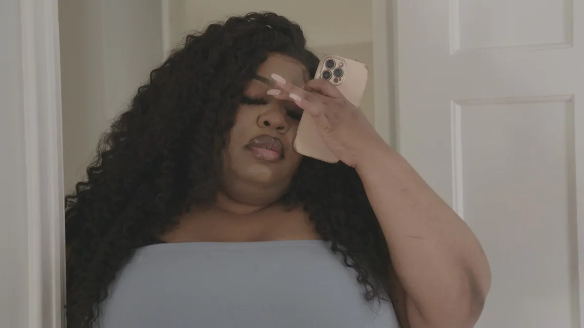 Monique with her hand on her forehead in an episode of 'Love During Lockup'