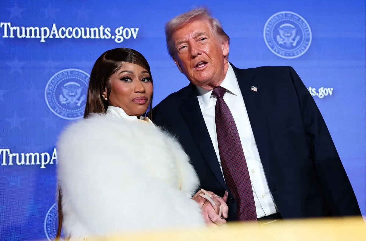 Nicki Minaj joins U.S. President Donald Trump on stage as he delivers remarks during the Treasury Department's Trump Accounts Summit