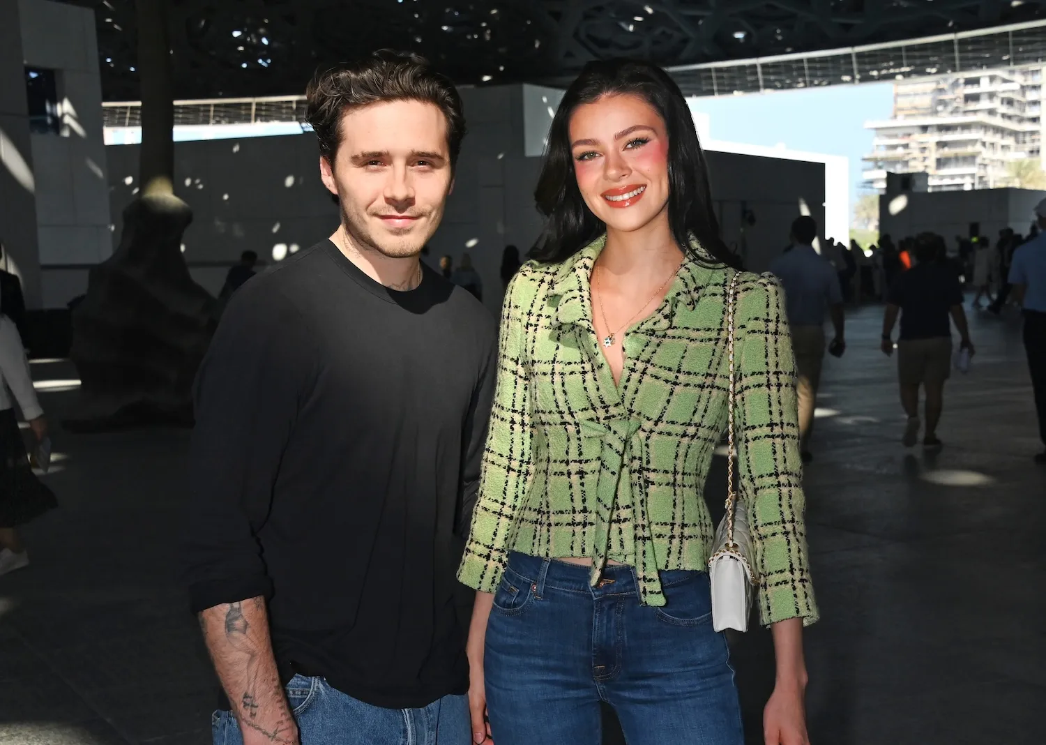 Brooklyn Beckham and Nicola Peltz Beckham posing together in December 2024 in Abu Dhabi