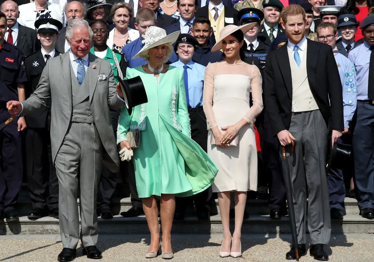 Prince Harry, King Charles, Queen Camilla, Meghan Markle, and guests pose for a photograph at Buckingham Palace