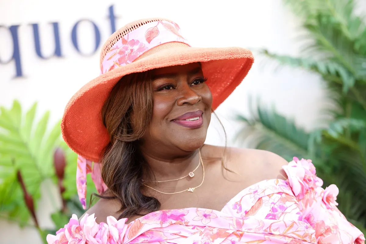 Retta, host of 'Ugliest House in America,' wearing a pink hat