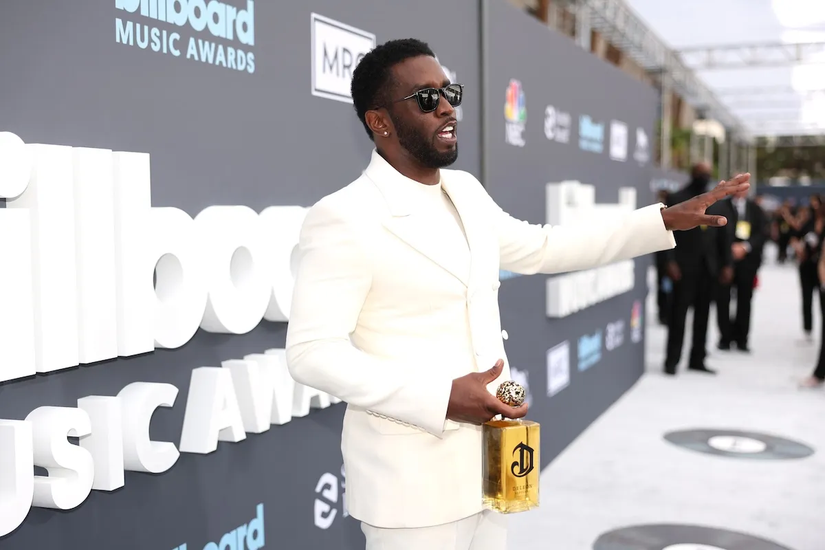Sean 'Diddy' Combs wearing all white with his arm outstretched at the 2022 Billboard Music Awards