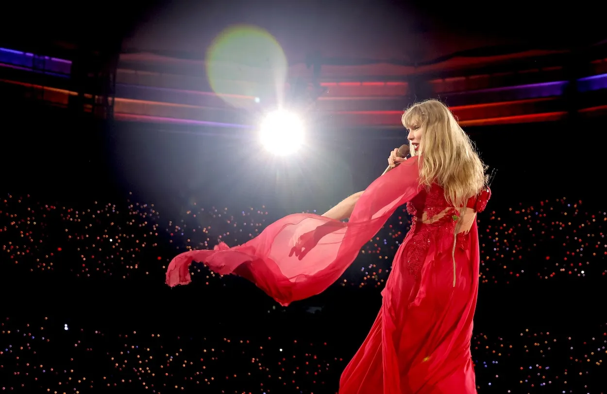 Taylor Swift in a flowing red dress while performing on stage during 'The Eras Tour'