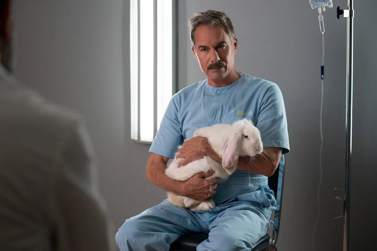 Eric McCormack holding a rabbit in 'The Hunting Party'